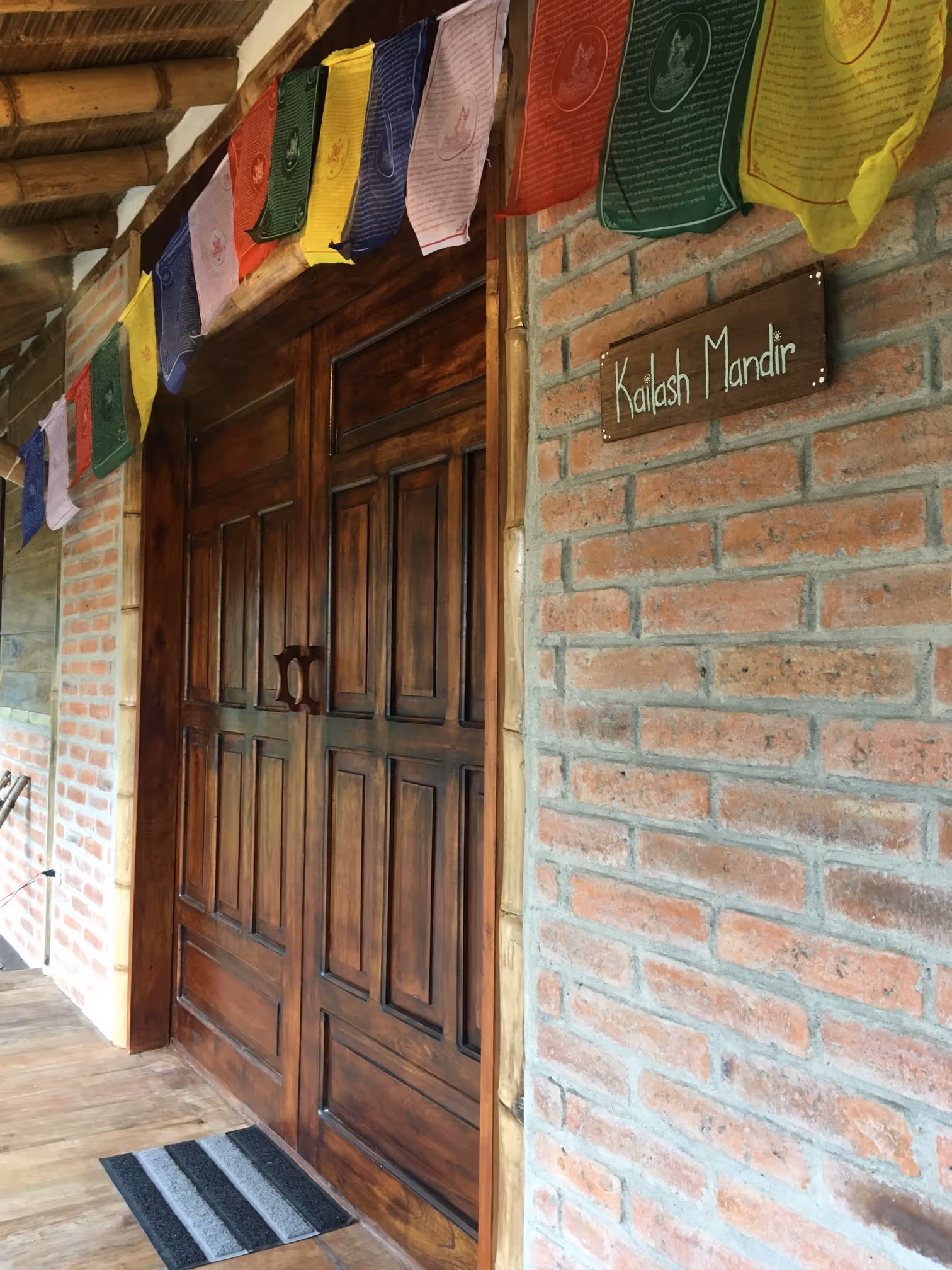 Entrance to the Kailash Mandir with Tibetan prayer flags at the Ashram